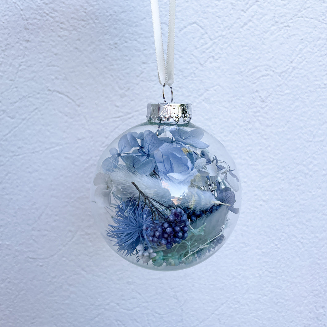Individually packaged clear glass Christmas bauble filled with blue and aqua preserved flowers. Unique Christmas tree decoration created by Melbourne florist Joyful Blooms. Perfect gift option for teachers gifts, stocking fillers, Christmas table settings.